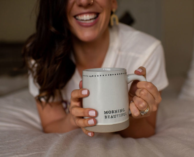 Megan smiling with coffee mug